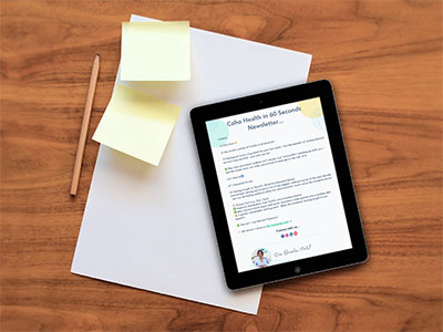 Coho Health Newsletter iPad mockup on a wood desk next to A4 paper and stickies