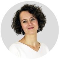 Circular image of Aga wearing a white top